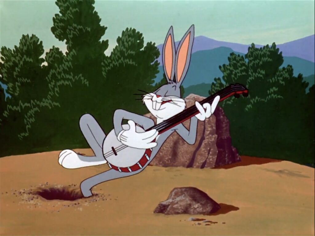 Bugs Bunny, an animated rabbit, smiles smugly while playing a banjo.