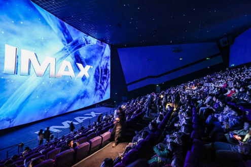 Large IMAX theatre with people seated in the audience