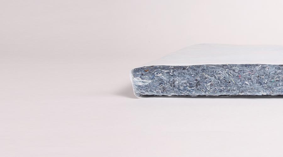 Shredded denim packaged as insulation.
