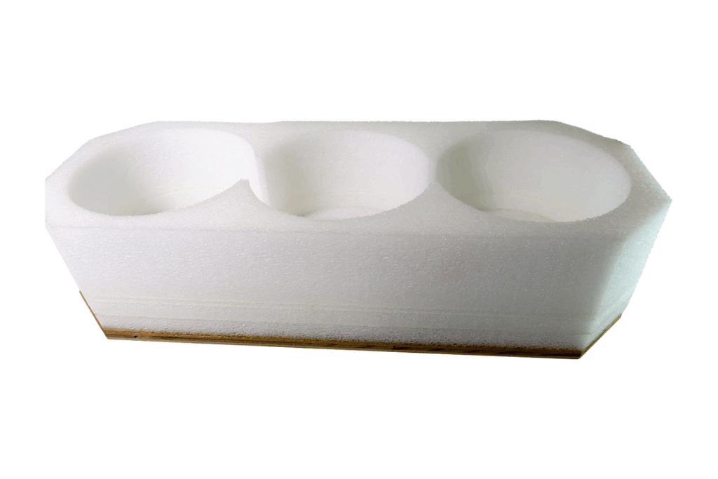A molded EPS shipping form to hold three cylindrical items.